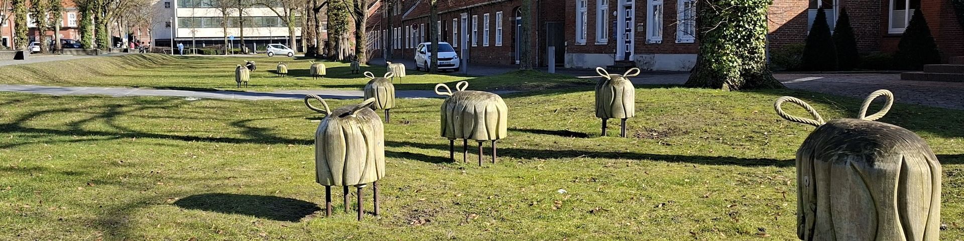Schaffiguren aus Holz und Metallstreben auf einer Wiese am Georgswall